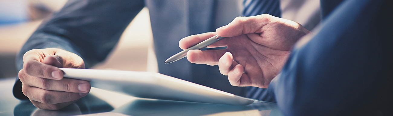 Close-up of two people going over a contract